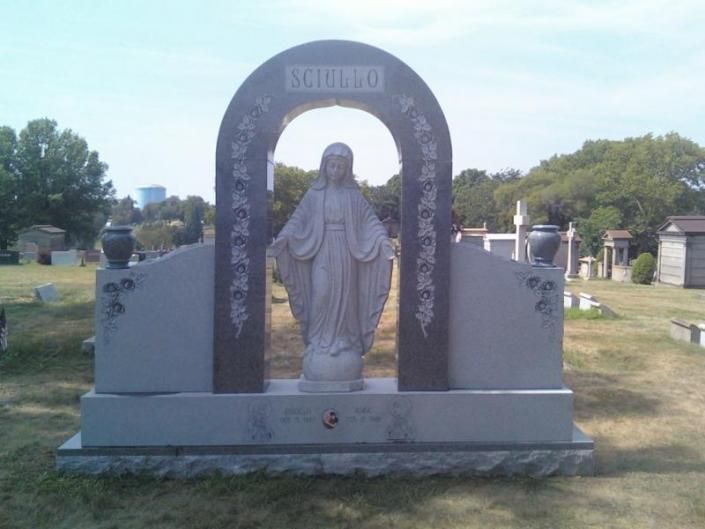A statue of a woman in a cemetery with the name isabella on it
