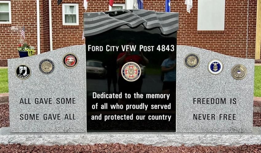 A ford city veterans memorial with a brick building in the background