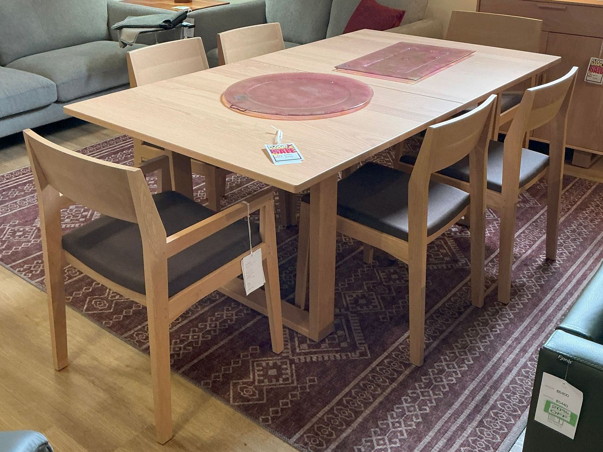 Copeland Iso Dining Table in Bright Oak with four side chairs and 2 arm chair.