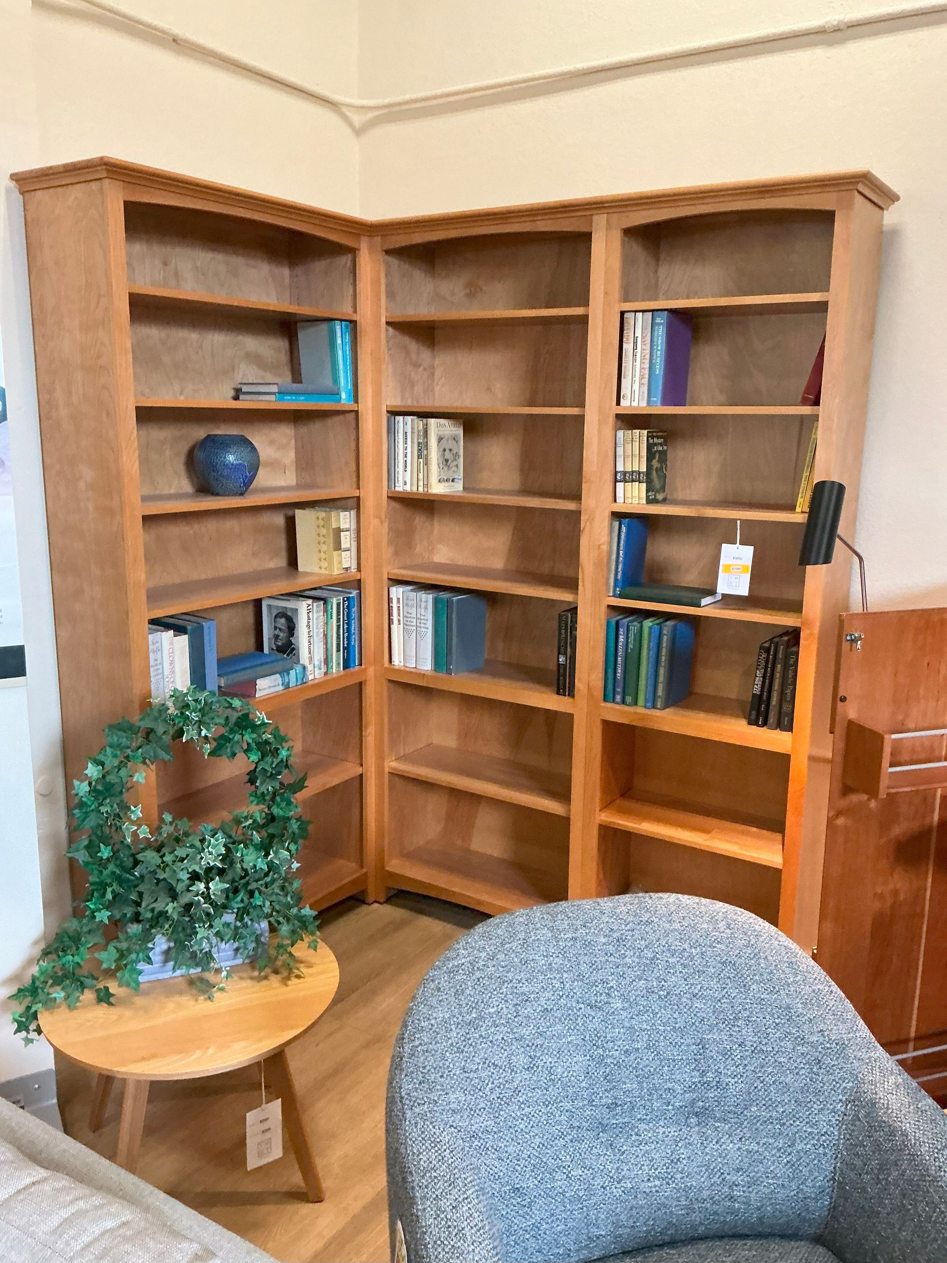Corner bookcase system shown in natural Alder