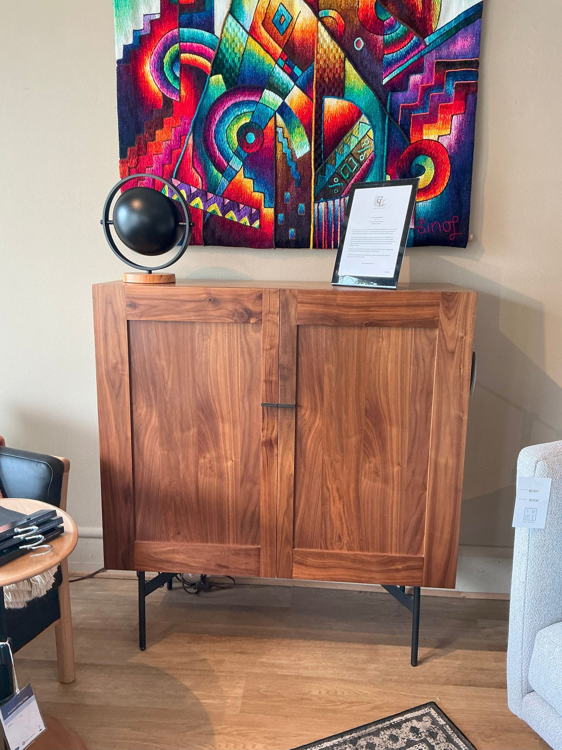 Harmony Tall storage cabinet in natural Walnut with black metal legs.