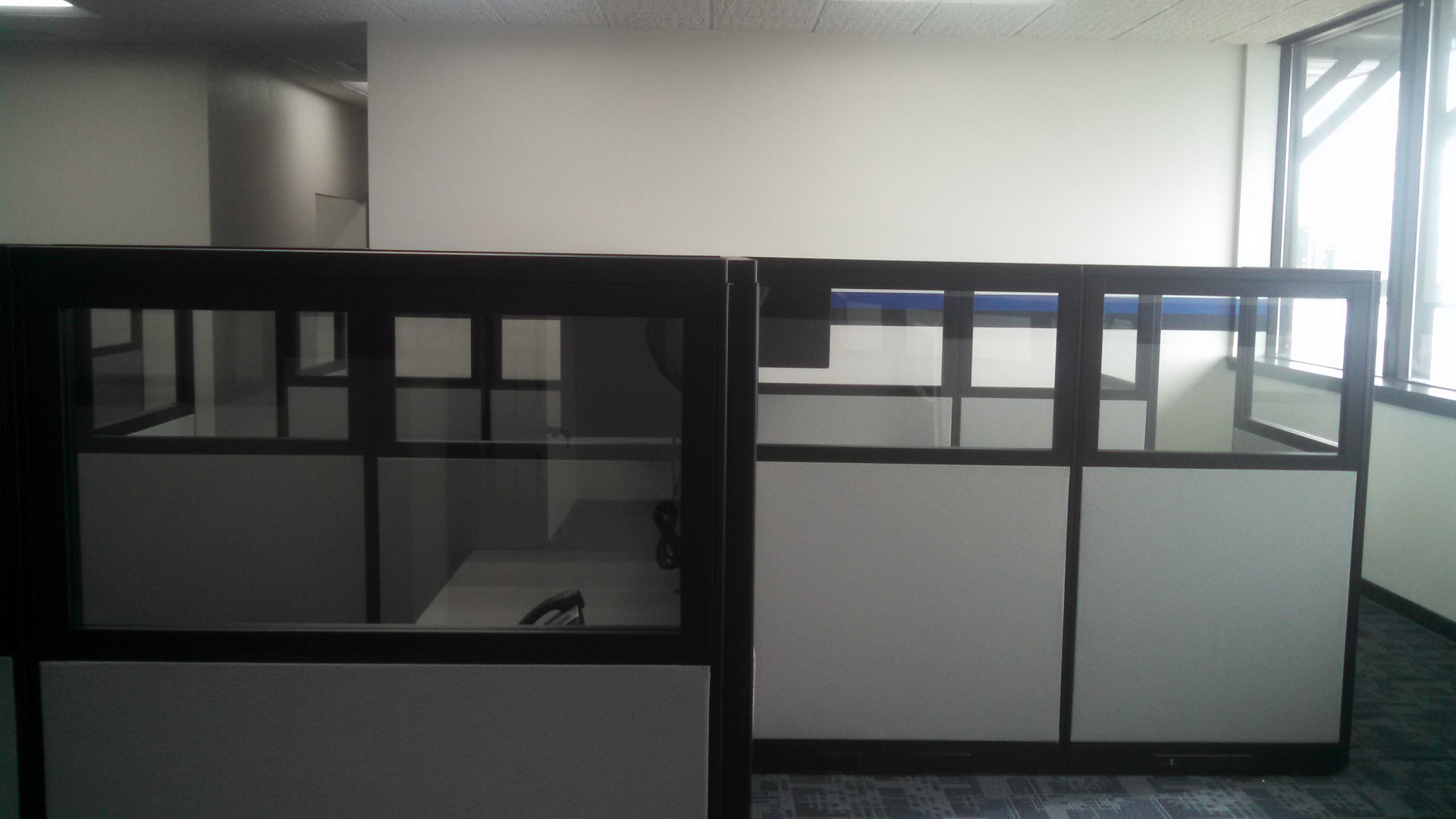 An empty office with cubicles and a window