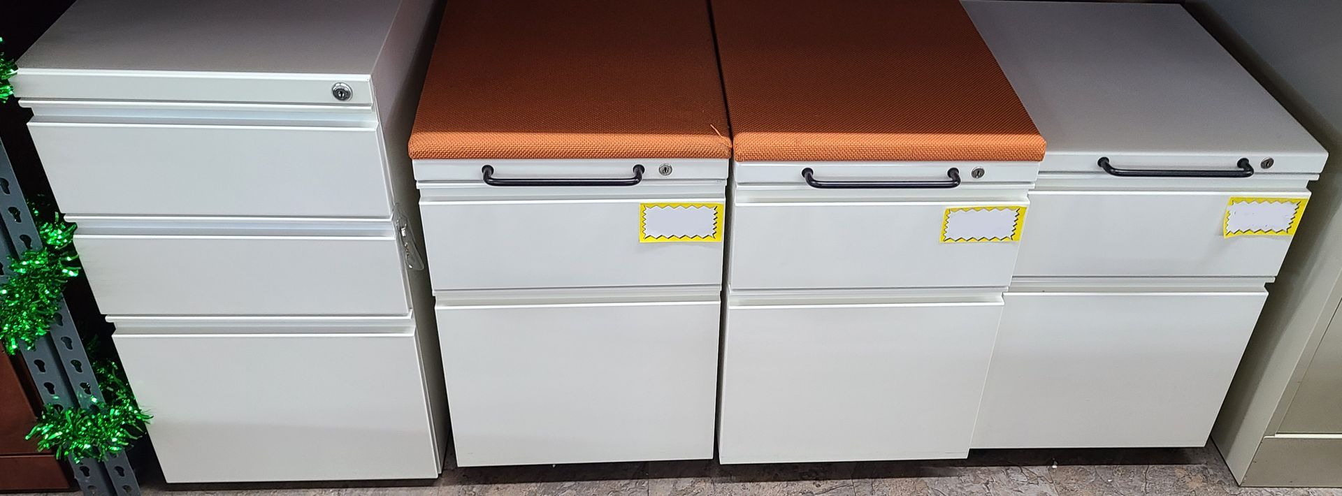 A bunch of filing cabinets are lined up in a room.
