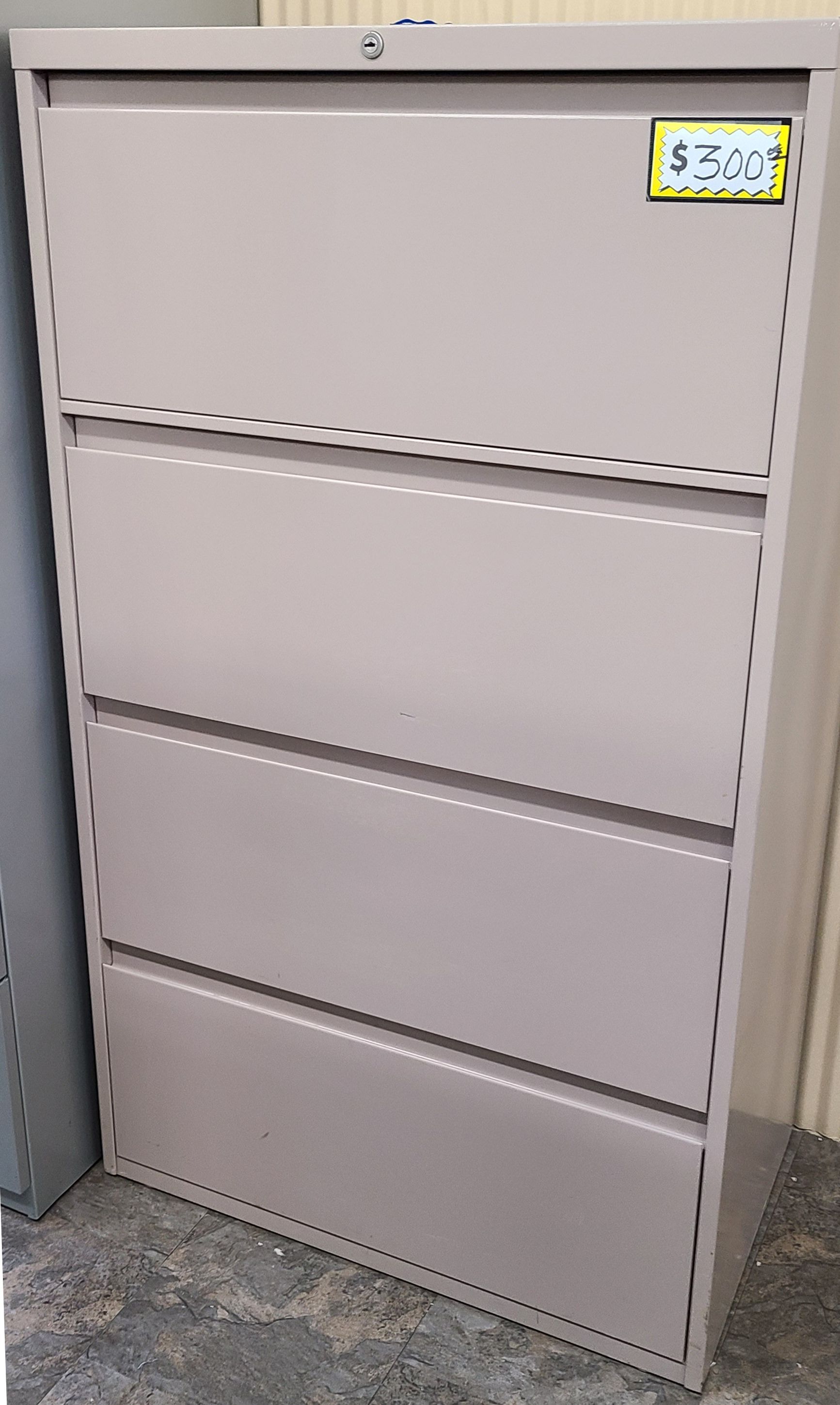 A filing cabinet with three drawers and a price tag on it.