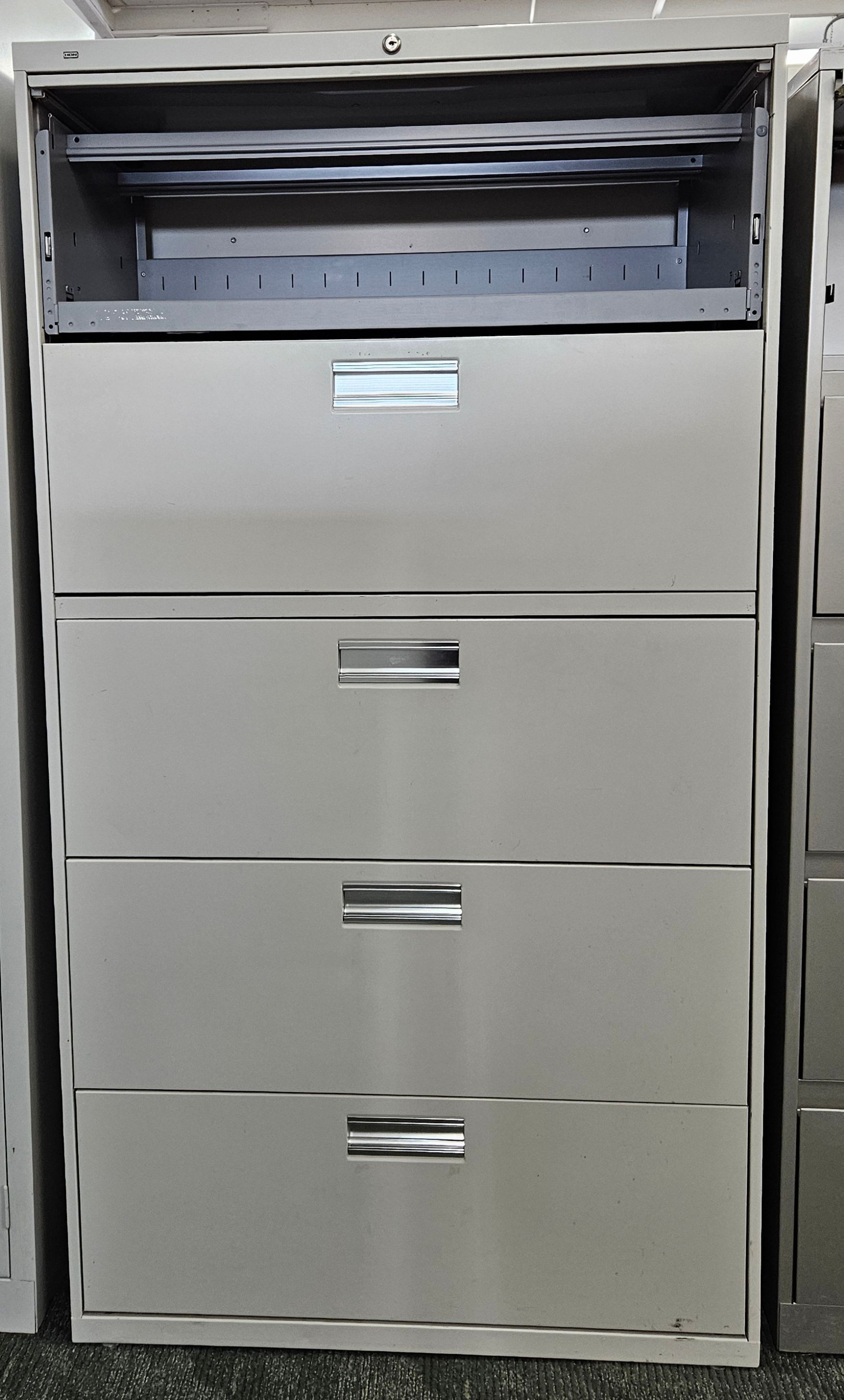 A row of filing cabinets are sitting next to each other on the floor.
