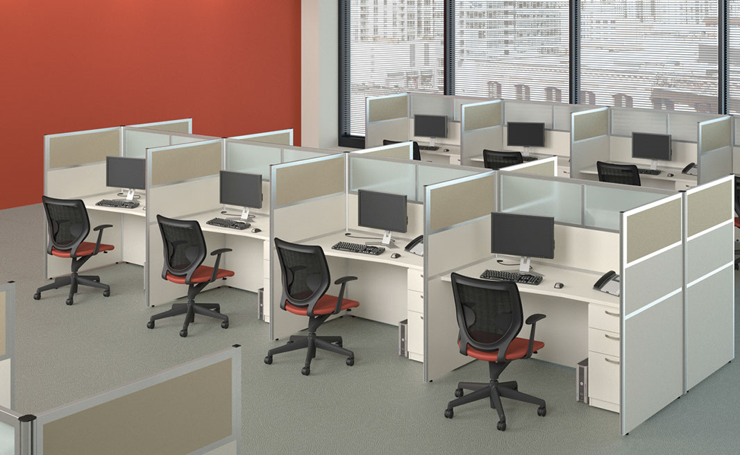 A row of cubicles with computers and chairs in an office.