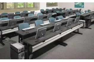A classroom with a lot of computers on the desks