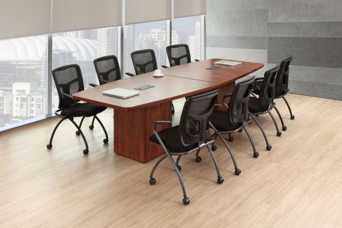 A conference room with a long wooden table and chairs.