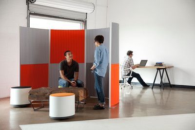 A man and a woman are standing next to each other in a room.