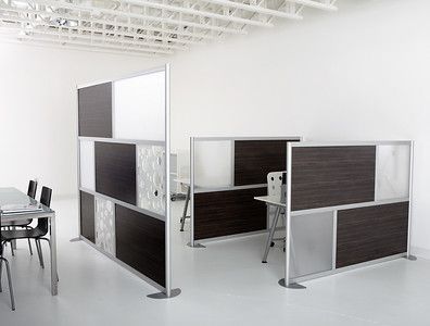 A room with a table and chairs and a divider between them.