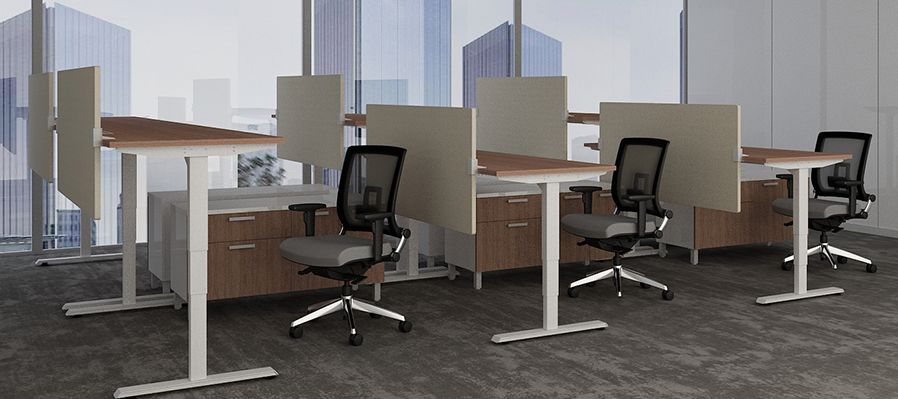 A row of standing desks and chairs in an office.