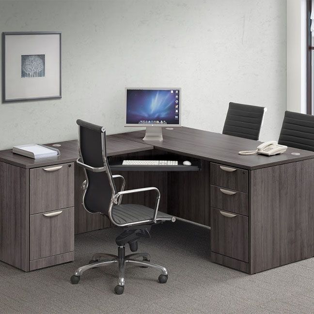 A desk with a computer on it and a chair