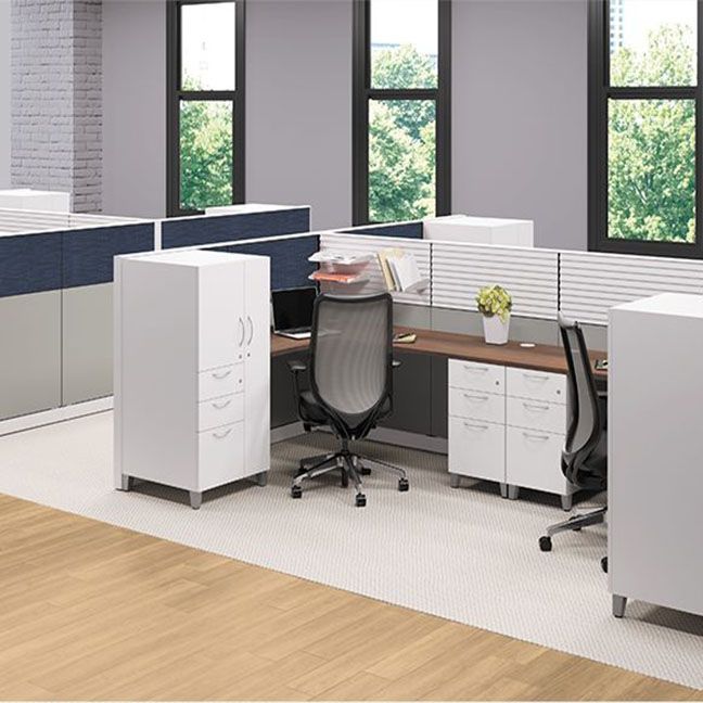 A cubicle in an office with a desk and chair