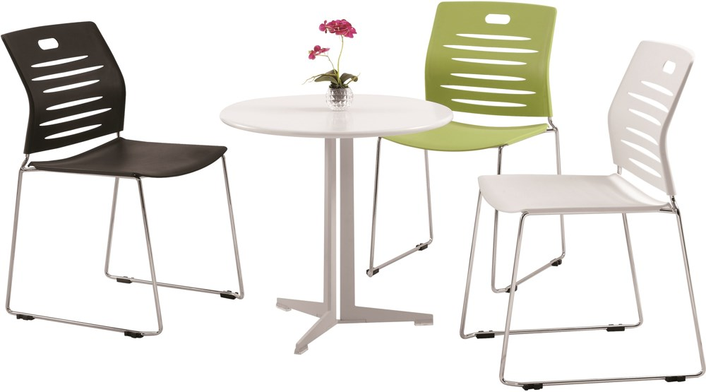 Three chairs and a table with a vase of flowers on it