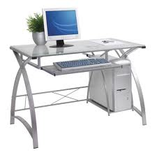 A computer desk with a computer and keyboard on it.