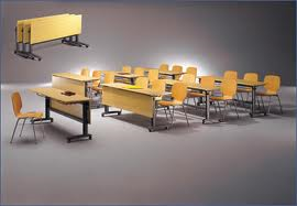 A row of wooden tables and chairs in a classroom.