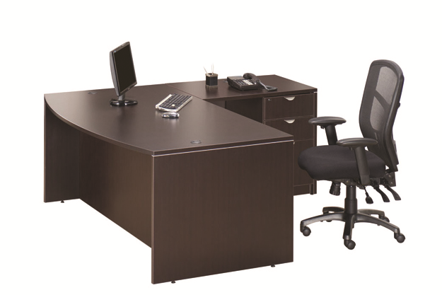 A desk with a computer and a chair on it