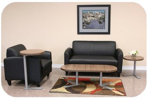 A living room with a couch a chair and two tables