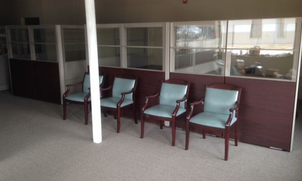 A row of chairs are lined up in a waiting room