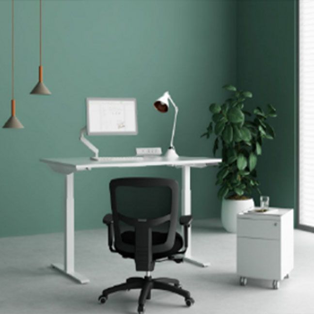 A desk with a computer on it and a chair