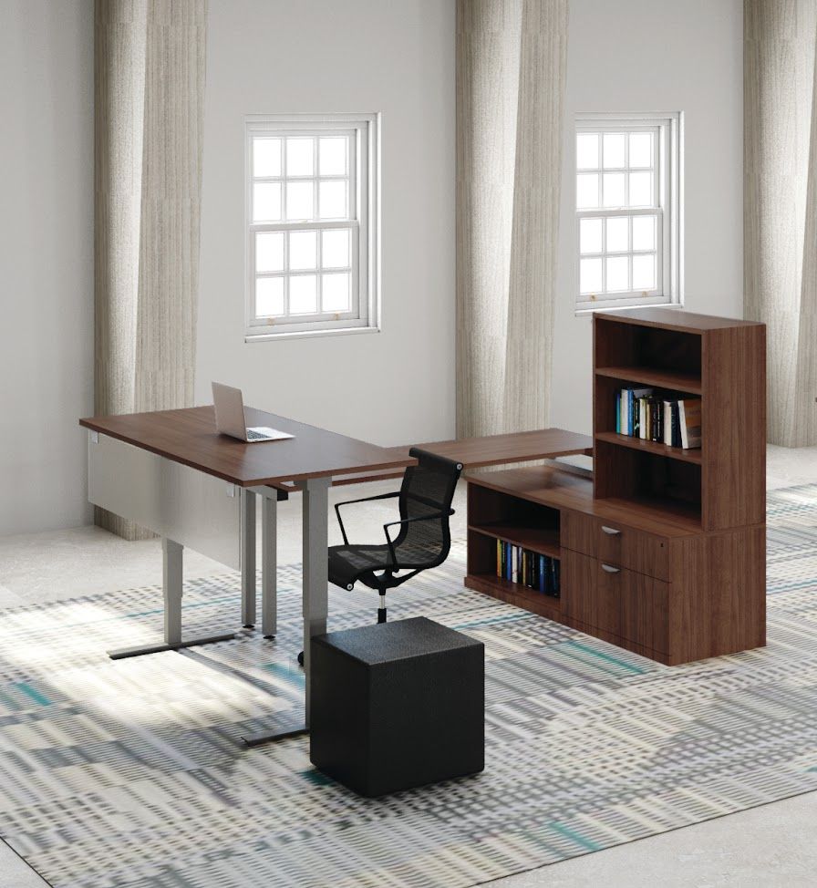 There is a desk with a laptop on it and a chair in the room.