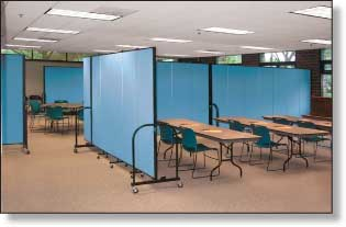 A room with blue dividers and tables and chairs