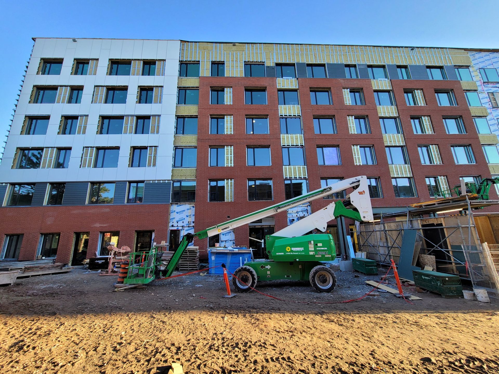 A large house with a swimming pool in the backyard at night.