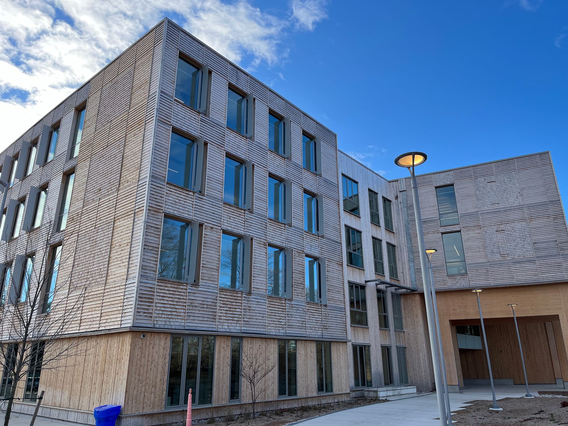 Looking up at a brick building with lots of windows.
