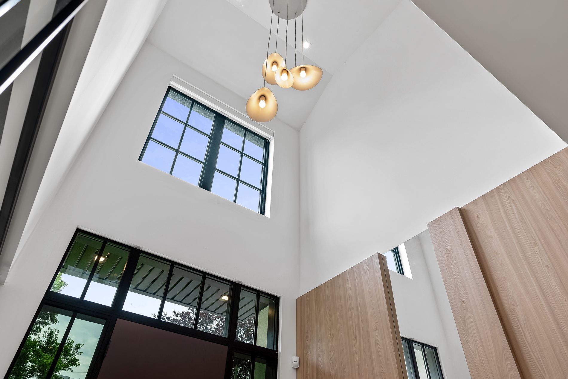 An empty room with a lot of windows and hardwood floors.