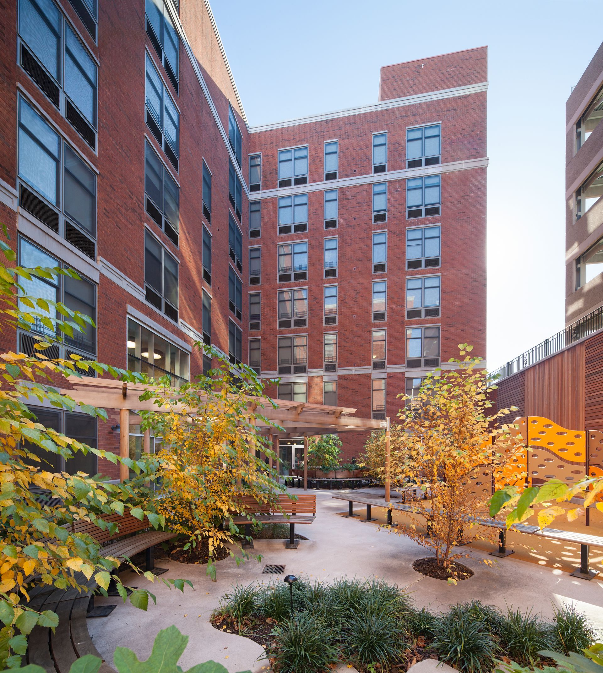 A large brick building with a courtyard in front of it