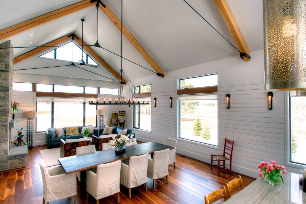 An empty room with a lot of windows and hardwood floors.
