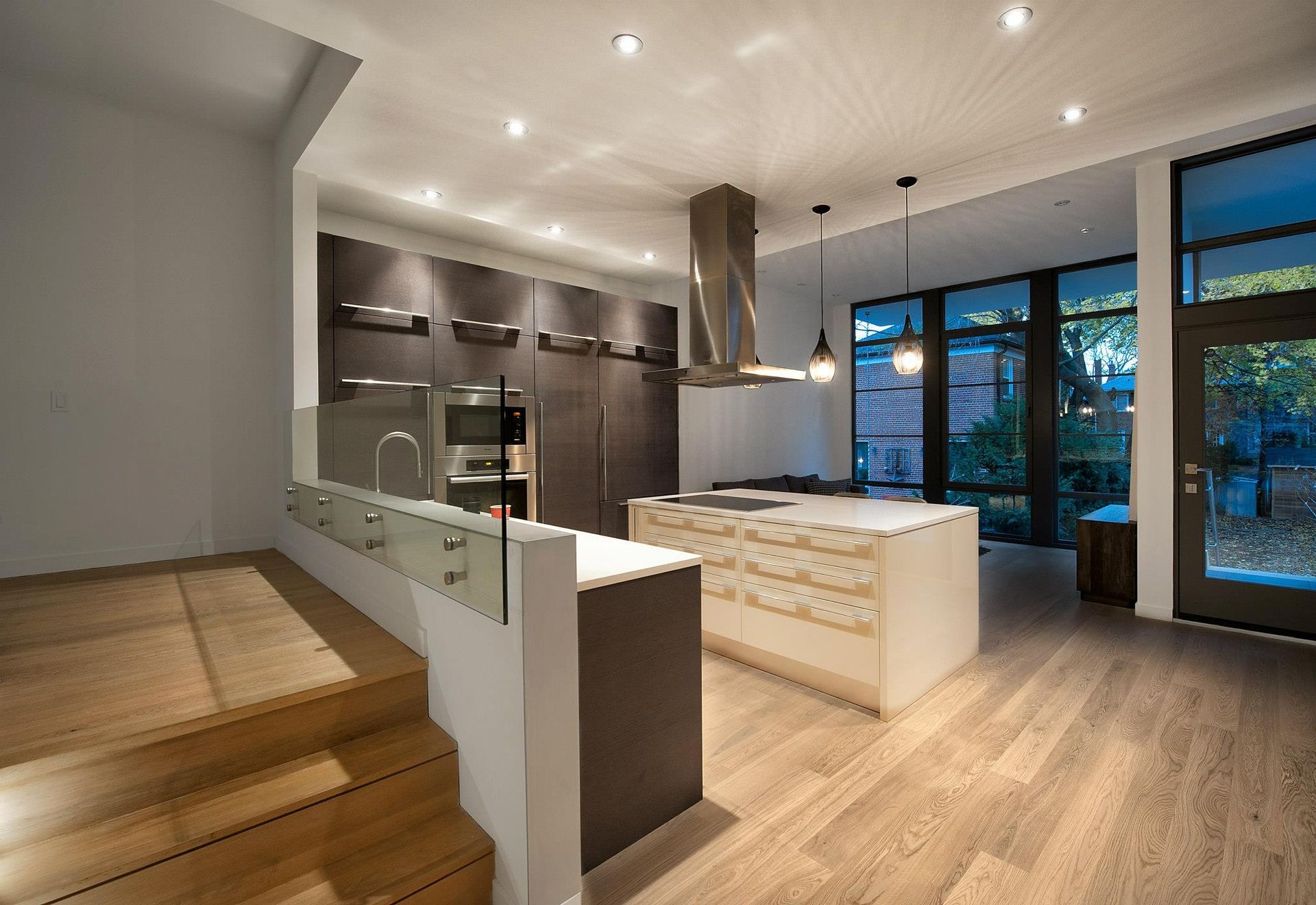 An empty room with a lot of windows and hardwood floors.