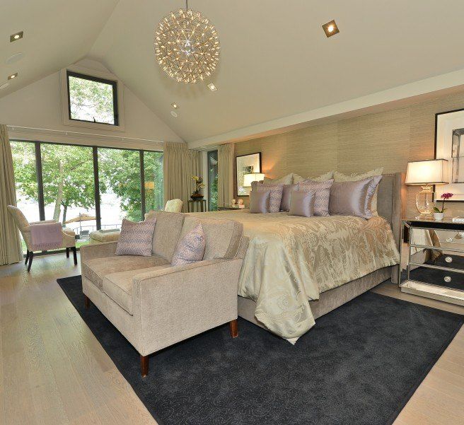 A bedroom with a large bed and a couch