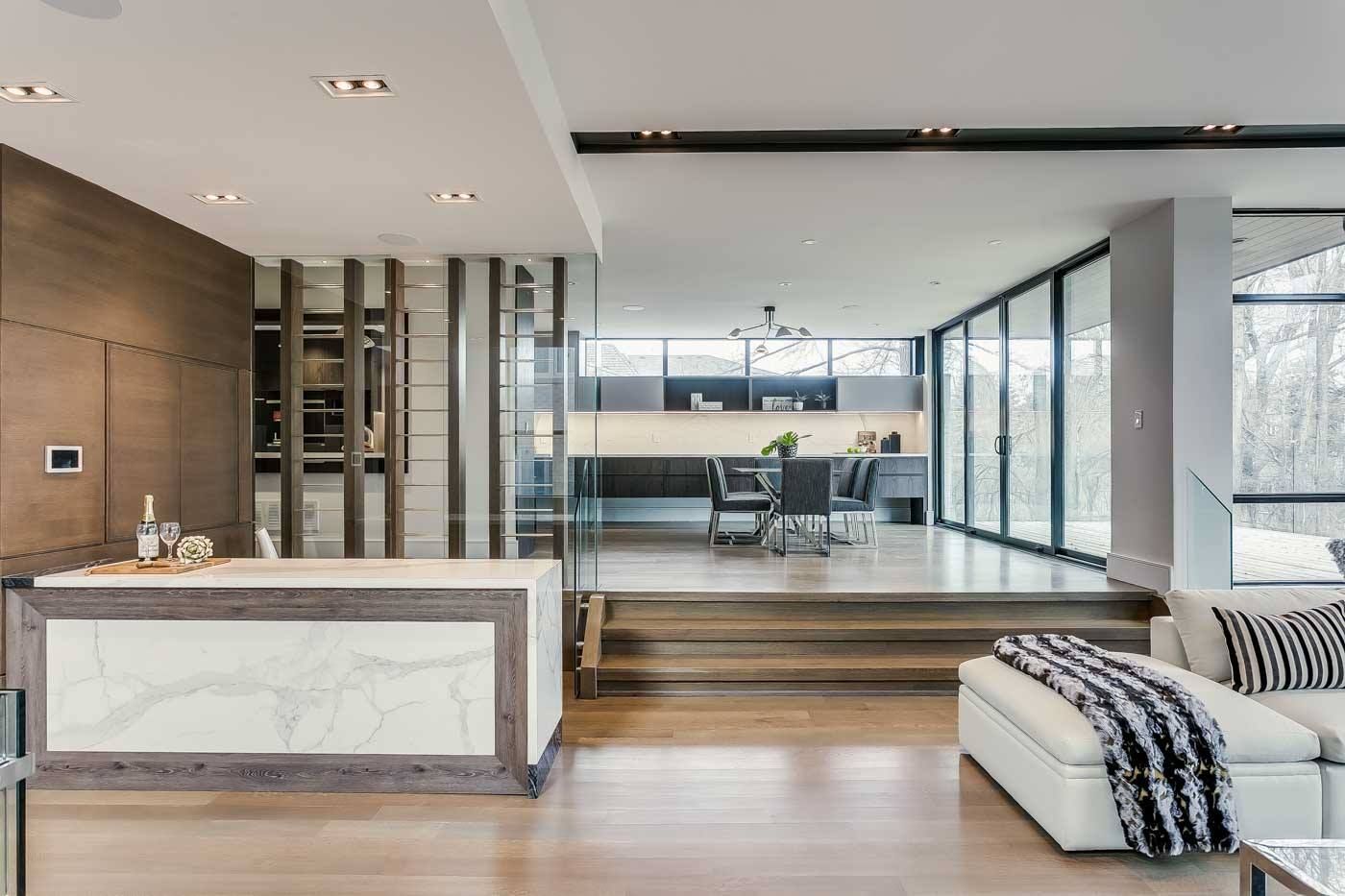 A living room with a white couch and a large island in the middle of the room.