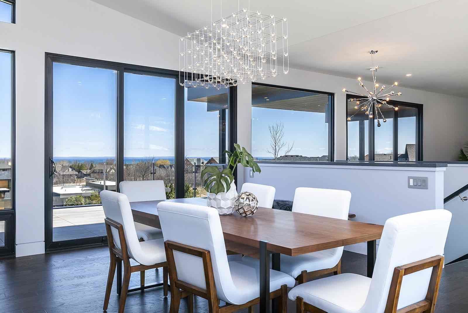 A dining room with a table and chairs and a chandelier.
