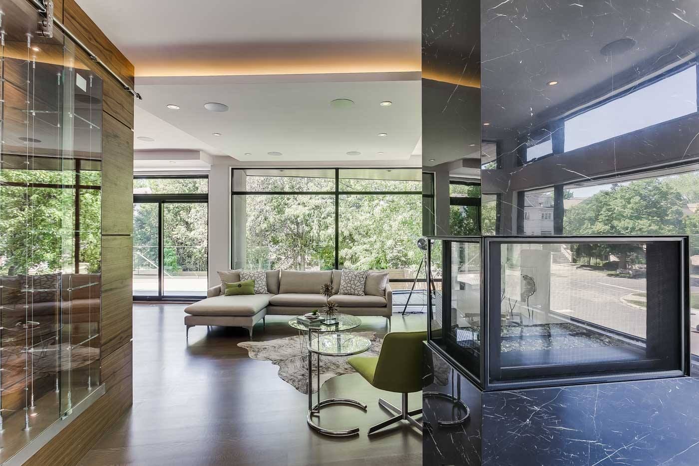 A hallway in a house with a bench and lots of windows