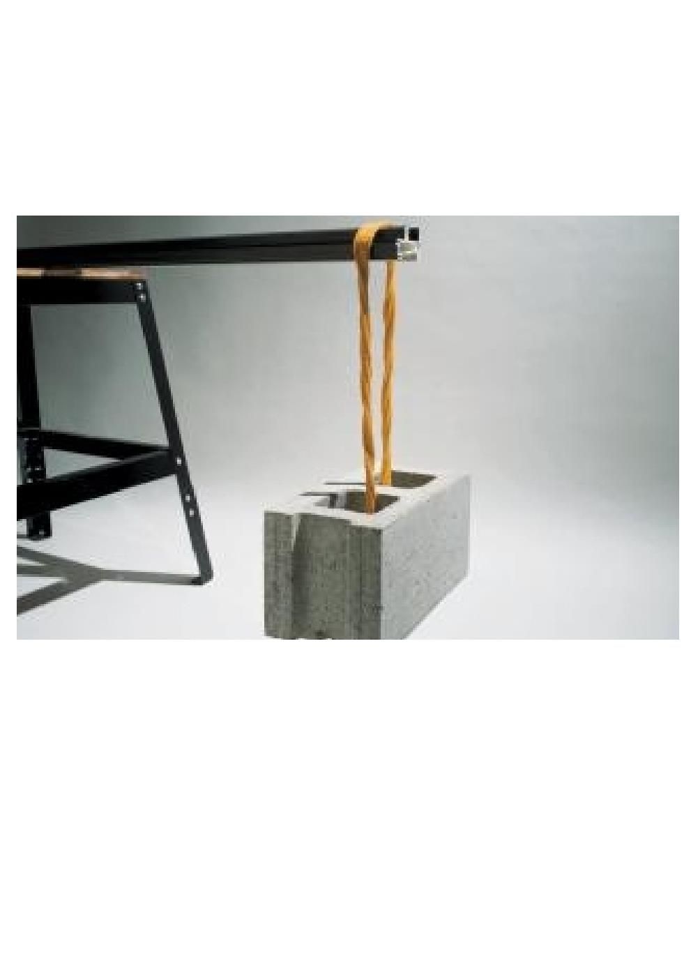 A rope is hanging from a concrete block on a table