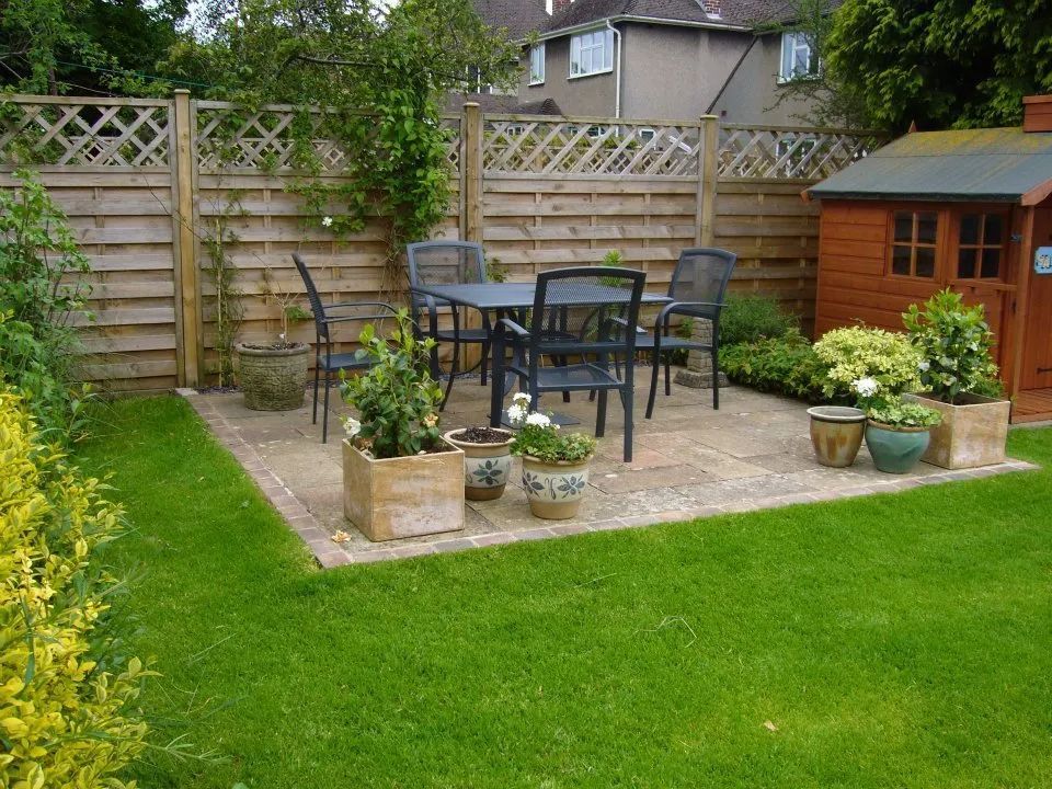 Urban Paving Bristol | A garden with a table and chairs and potted plants