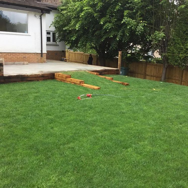 Urban Paving Bristol | A lush green lawn in front of a house with a wooden deck.