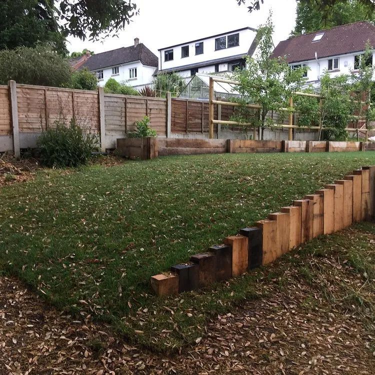 Urban Paving Bristol | A back garden with a wooden fence and a lush green lawn