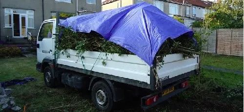 Urban Paving Bristol | A white truck with a blue tarp on top of it.