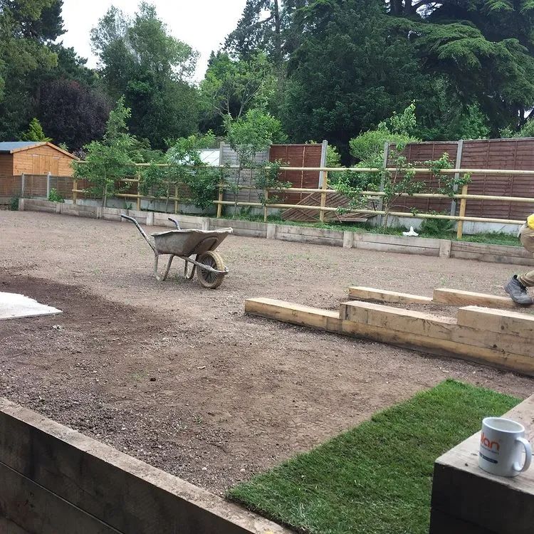 Urban Paving Bristol | A wheelbarrow is sitting in the middle of a dirt field