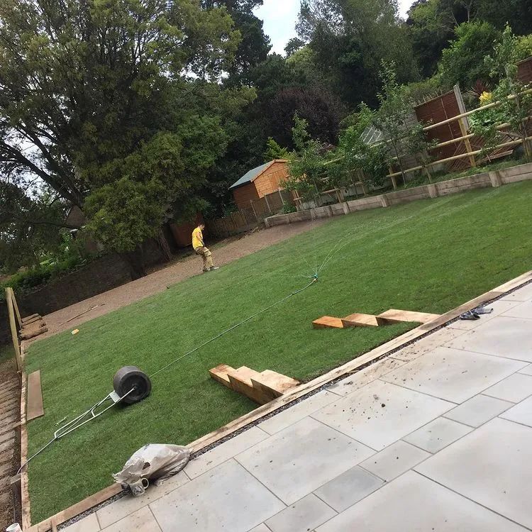 Urban Paving Bristol | A man is standing in the middle of a lush green lawn.