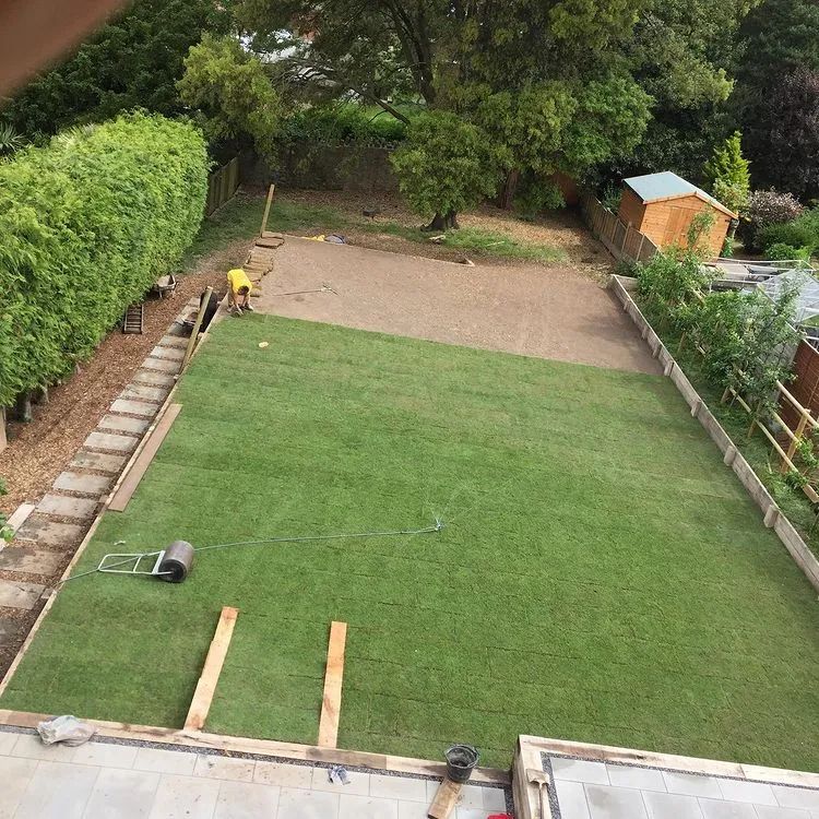 Urban Paving Bristol | A large lawn is being installed in a back garden.