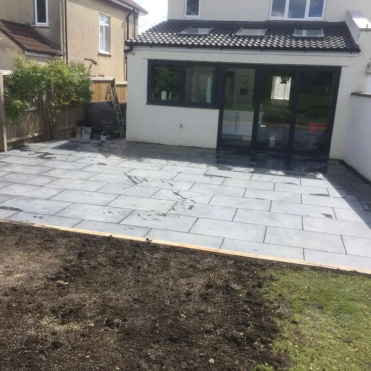 Urban Paving Bristol | A patio in front of a house with a sliding glass door.