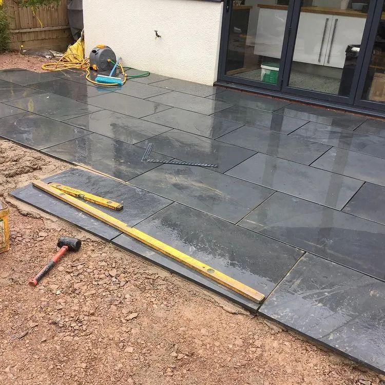 Urban Paving Bristol | A patio is being built with a hammer and a ruler.