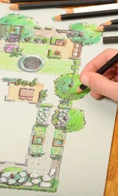 Urban Paving Bristol | A person is drawing a garden with a pencil on a piece of paper.