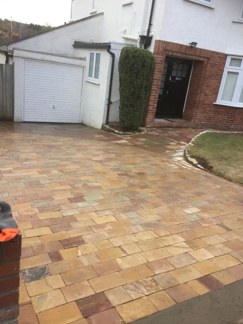 Urban Paving Bristol | A brick driveway in front of a house with a garage.