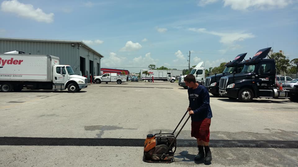 Man Doing Asphalt Paving — Fort Myers, FL — Southwest Florida Sealcoating