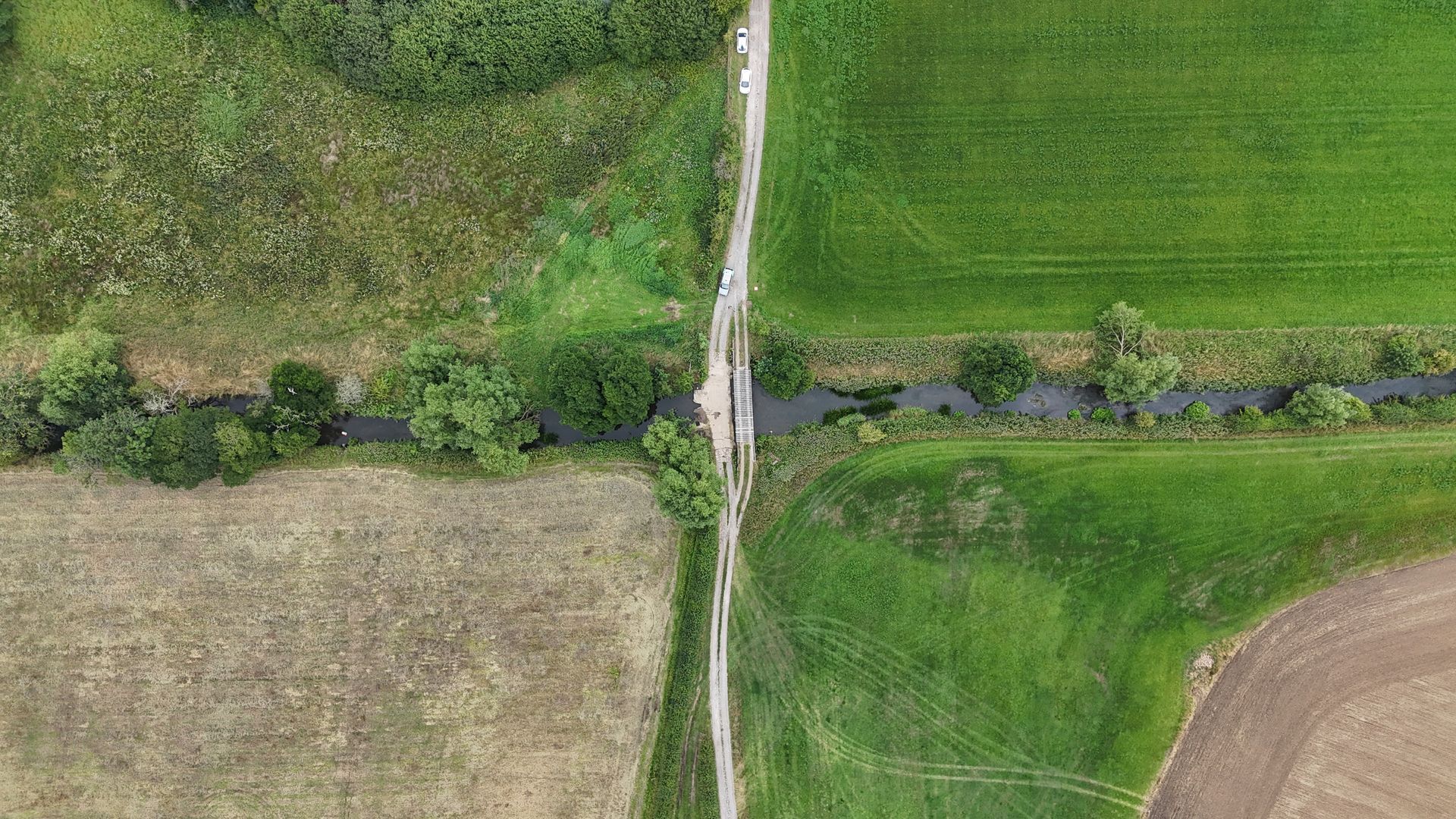 Drone footage of a ford in a beck and the surrounding landscape.
